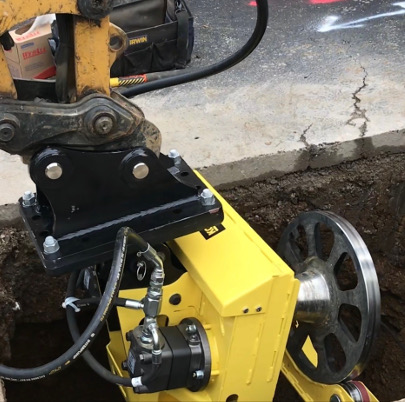 Kobus pipe puller positioned in excavation replacing lead water pipes